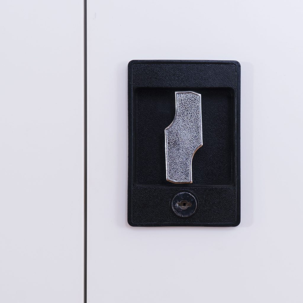 Close-up of black recessed handle key lock mechanism on steel door.